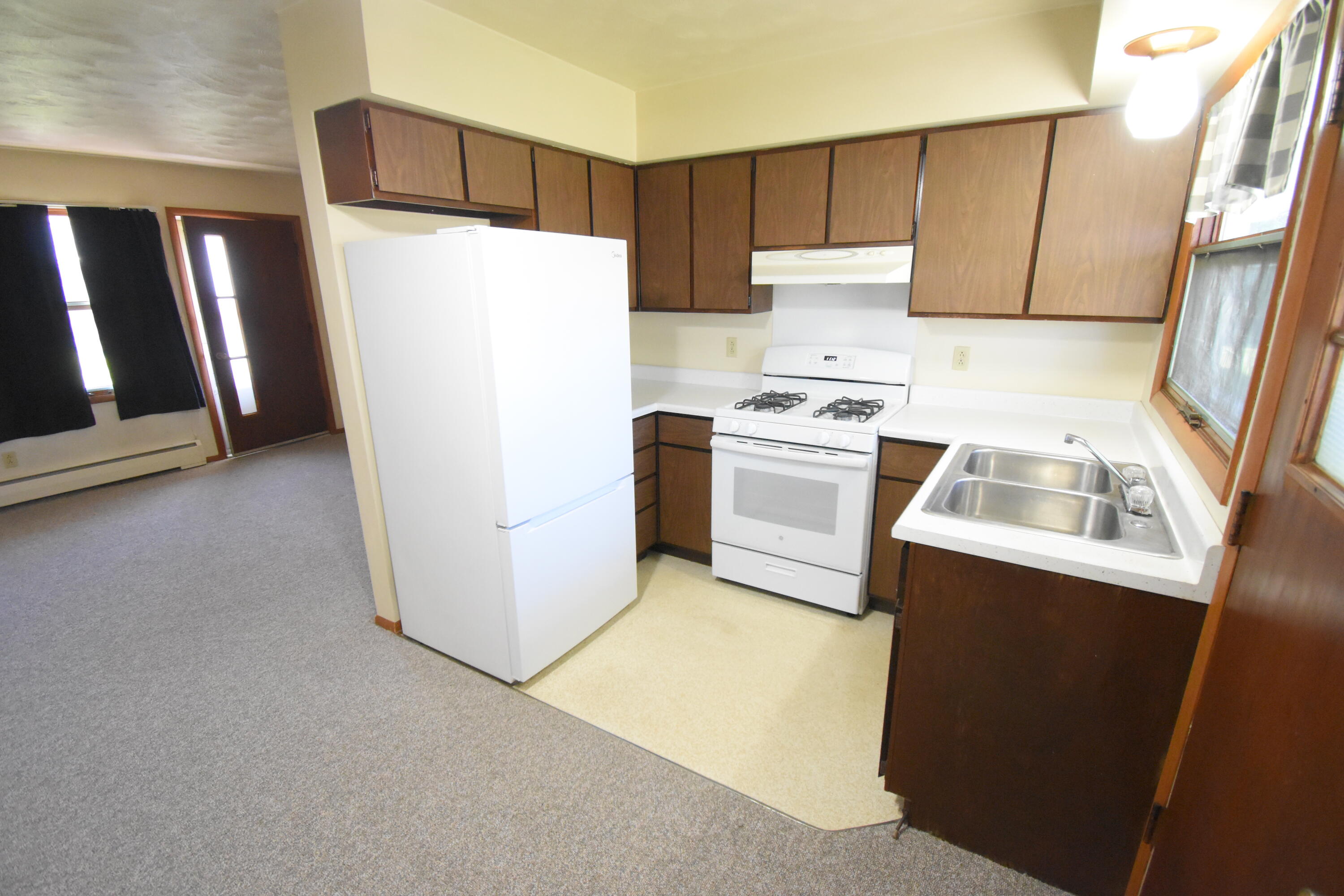 981 East Washington Street Rensselaer, IN 47978 - Photo 7 of 21 a white refrigerator freezer sitting inside of a kitchen