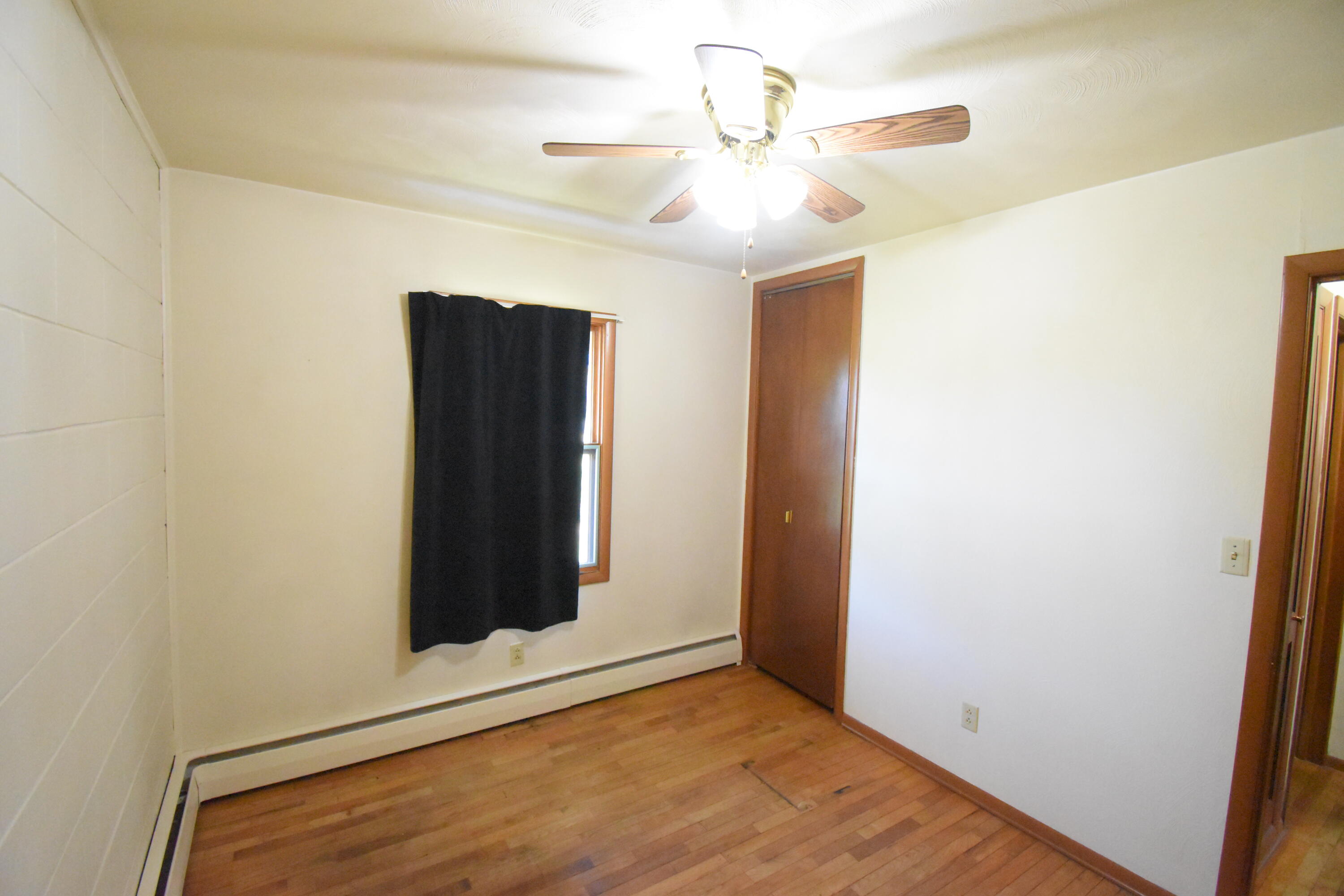 981 East Washington Street Rensselaer, IN 47978 - Photo 10 of 21 an empty room with closet and a chandelier fan