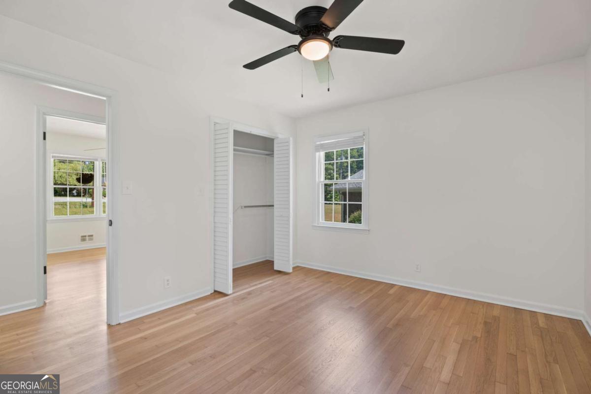 865 Old Tucker Road Stone Mountain, GA 30087 - Photo 30 of 57 wooden floor in an empty room with a window