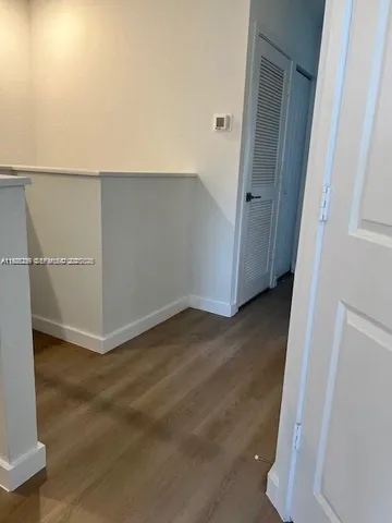 an empty room with wooden floor