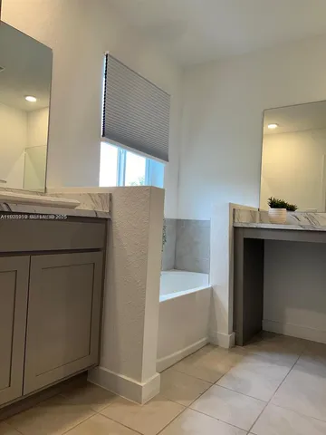 a room with a sink cabinets and utility room