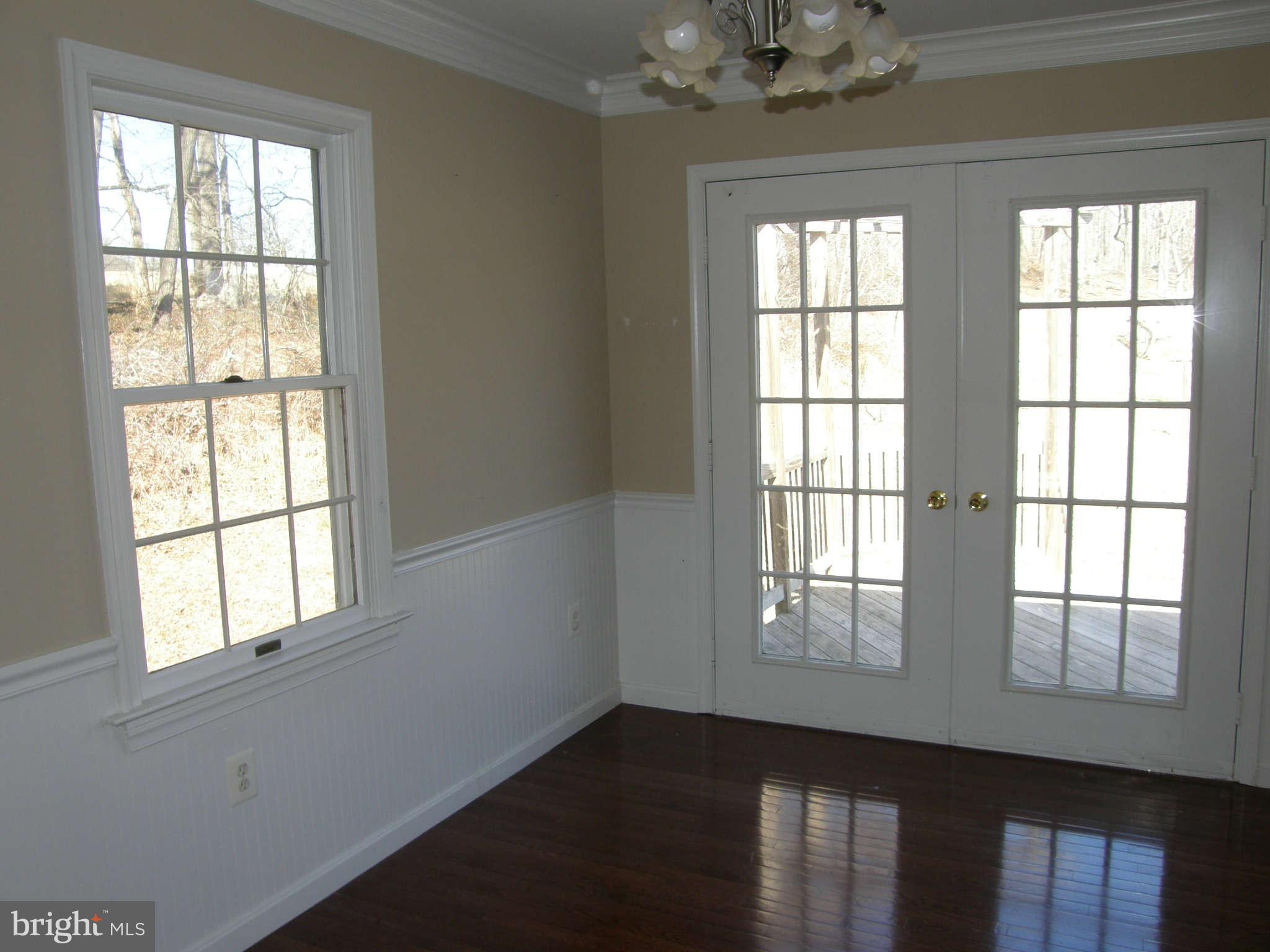 8230 Old Stillhouse Road Rixeyville, VA 22737 - Photo 11 of 30 a view of an empty room with wooden floor and windows