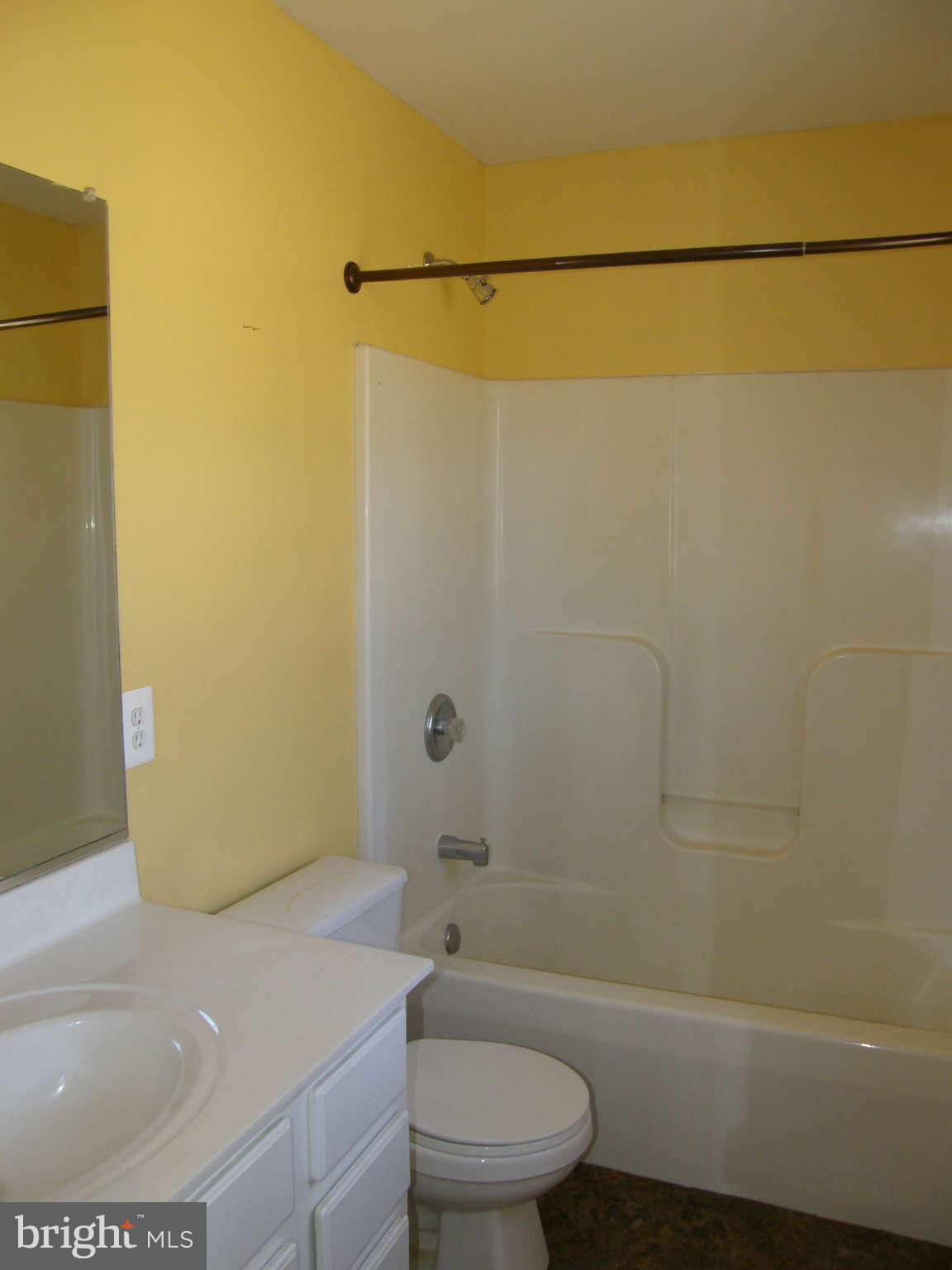 8230 Old Stillhouse Road Rixeyville, VA 22737 - Photo 19 of 30 a bathroom with a granite countertop sink toilet and shower