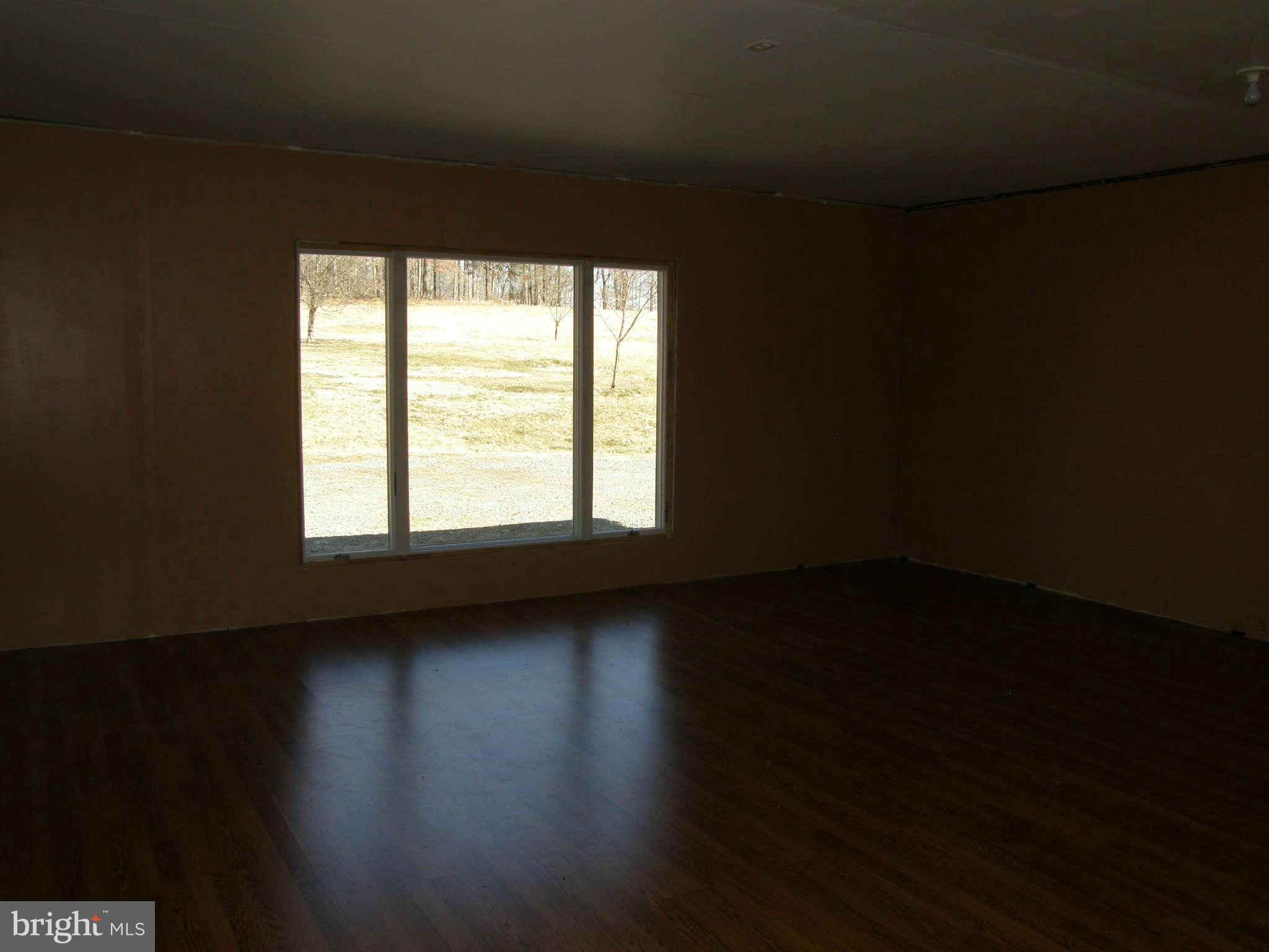 8230 Old Stillhouse Road Rixeyville, VA 22737 - Photo 25 of 30 a view of an empty room with wooden floor and a window
