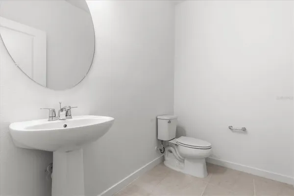 a bathroom with a sink a toilet and mirror