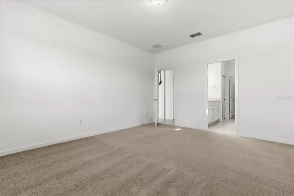 a view of an empty room and a window