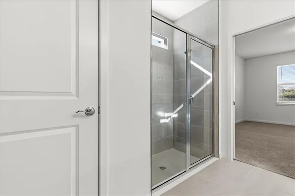 a bathroom with a glass shower door