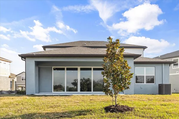 an aerial view of residential houses with outdoor space and river
