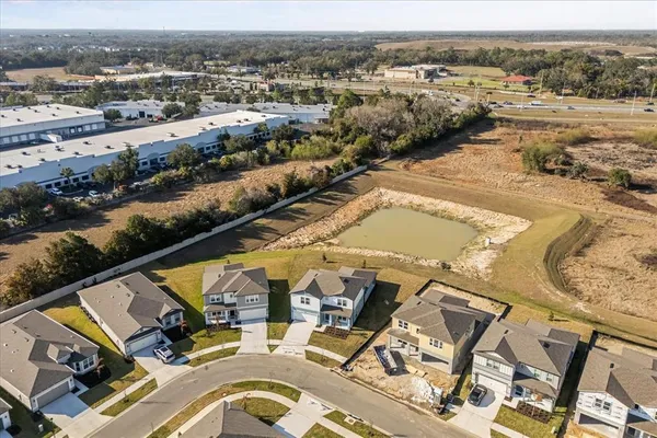 an aerial view of a house with a big yard
