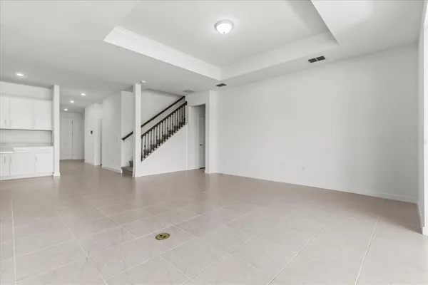 an empty room with white walls and stairs
