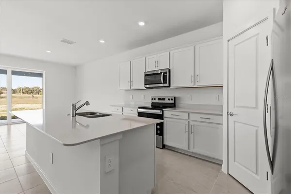 a kitchen with white cabinets and white appliances
