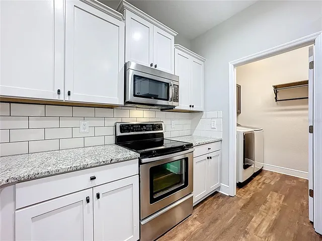 a living room with furniture and a ceiling fan