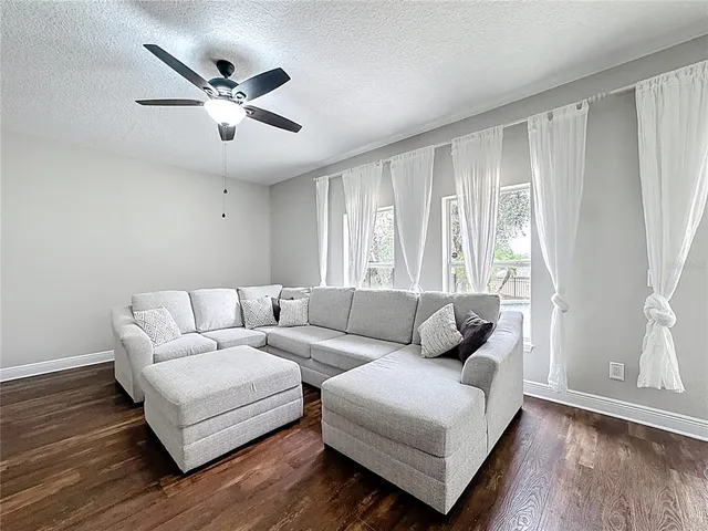 a living room with furniture and a chair