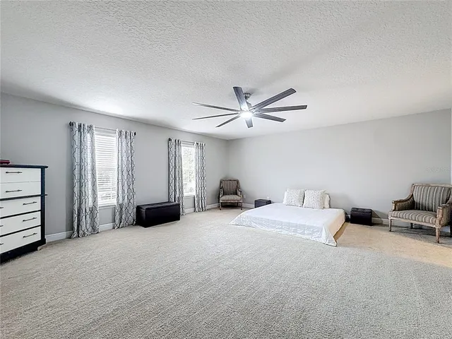 a view of a house with a backyard and a patio