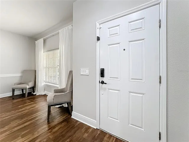 a kitchen with granite countertop cabinets stainless steel appliances and wooden floor