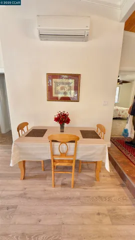 a dining room with furniture and wooden floor