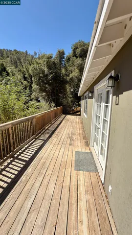 a view of balcony with wooden floor and fence