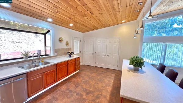 a large white kitchen with a large window