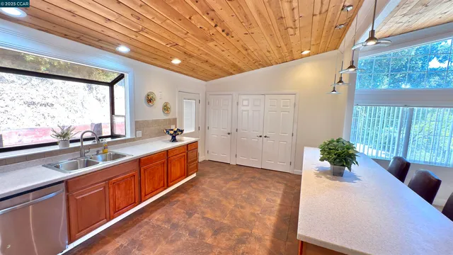 a large white kitchen with a large window