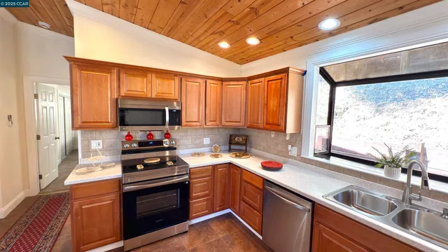 a kitchen that has a sink and a stove top oven