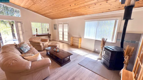 a living room with furniture fireplace and a large window