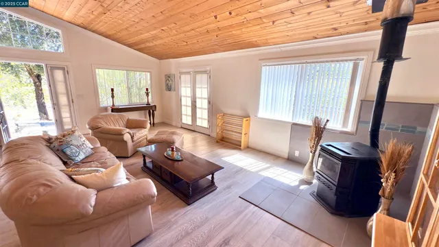 a living room with furniture fireplace and a large window