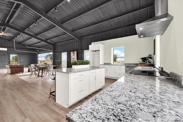 a kitchen with sink cabinets and wooden floor