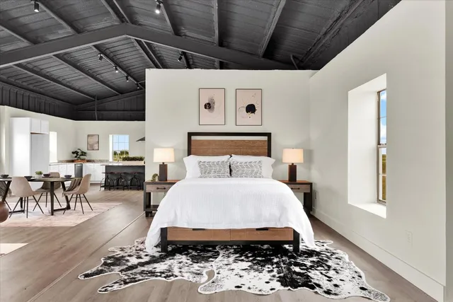 a bedroom with a bed and a window