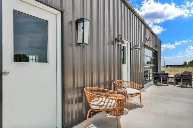 a balcony with table and chairs