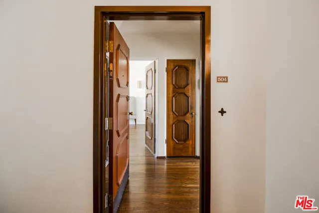 a view of a hallway with wooden door