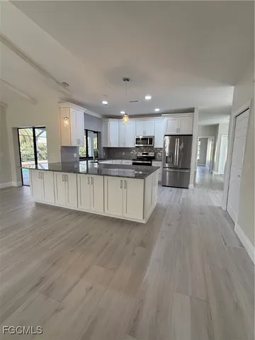 a view of kitchen with wooden floor