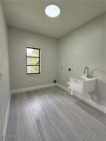 a view of a room with wooden floor and sink