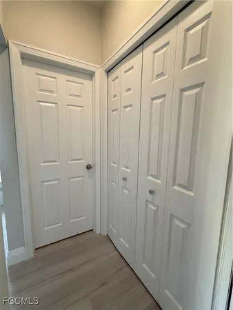 a view of a hallway with wooden floor