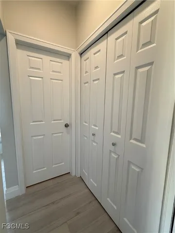a view of a hallway with wooden floor