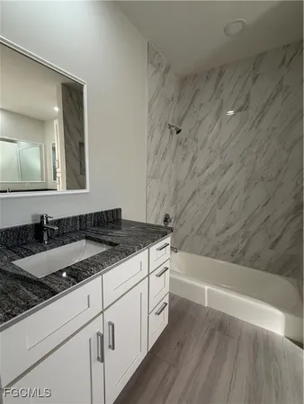 a bathroom with a sink and a mirror