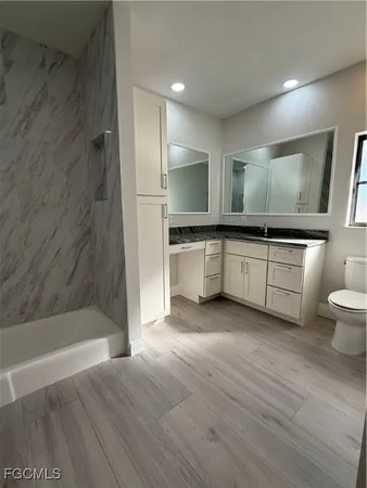a large kitchen with a sink and dishwasher stove top oven