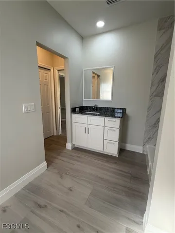 a kitchen with a sink and a stove top oven