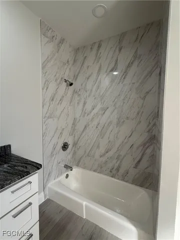 a bathroom with a bathtub and shower