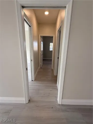 a view of a hallway with wooden floor