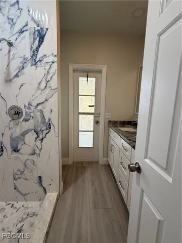 a bathroom with a granite countertop tub and a window