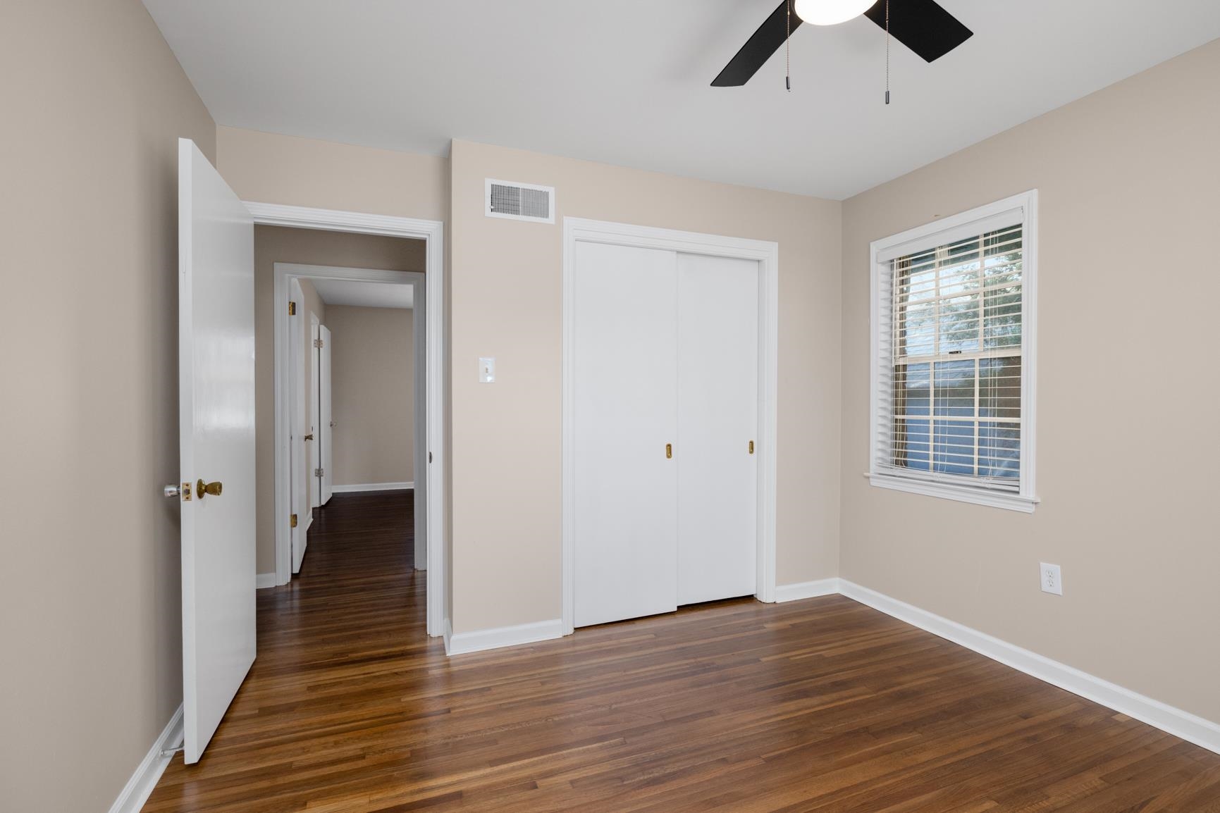 7223 Renda Street Millington, TN 38053 - Photo 20 of 24 an empty room with wooden floor and windows
