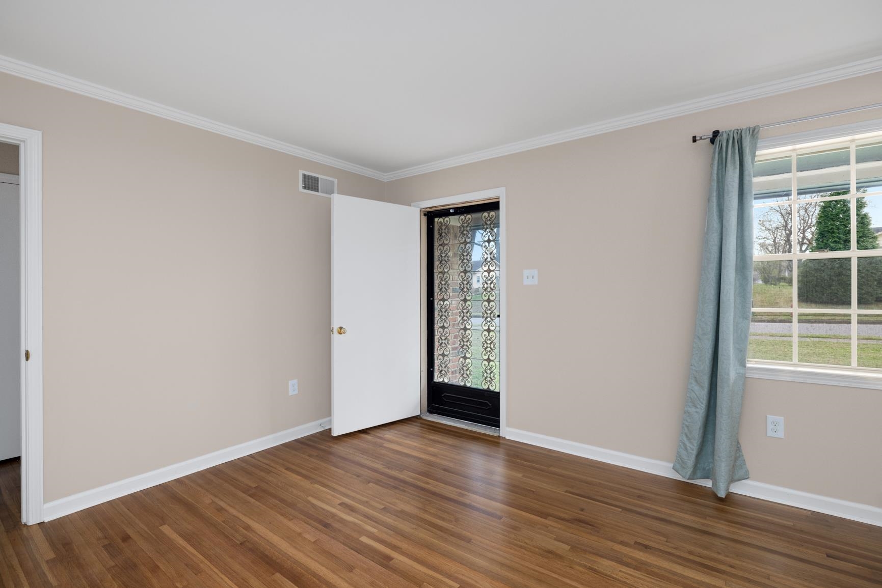 7223 Renda Street Millington, TN 38053 - Photo 5 of 24 a view of an empty room with wooden floor and a window