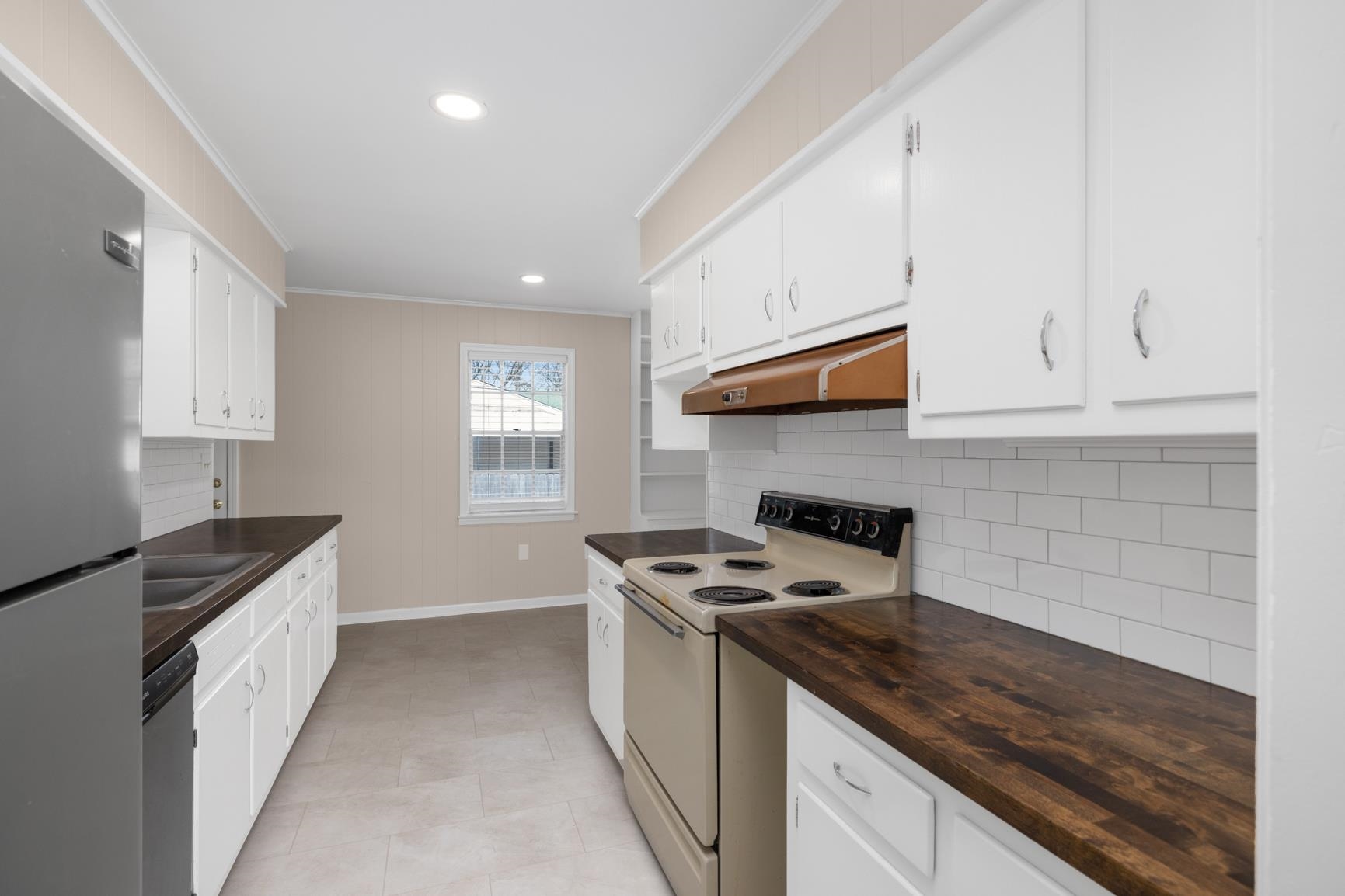 7223 Renda Street Millington, TN 38053 - Photo 7 of 24 a kitchen with granite countertop a stove sink and cabinets