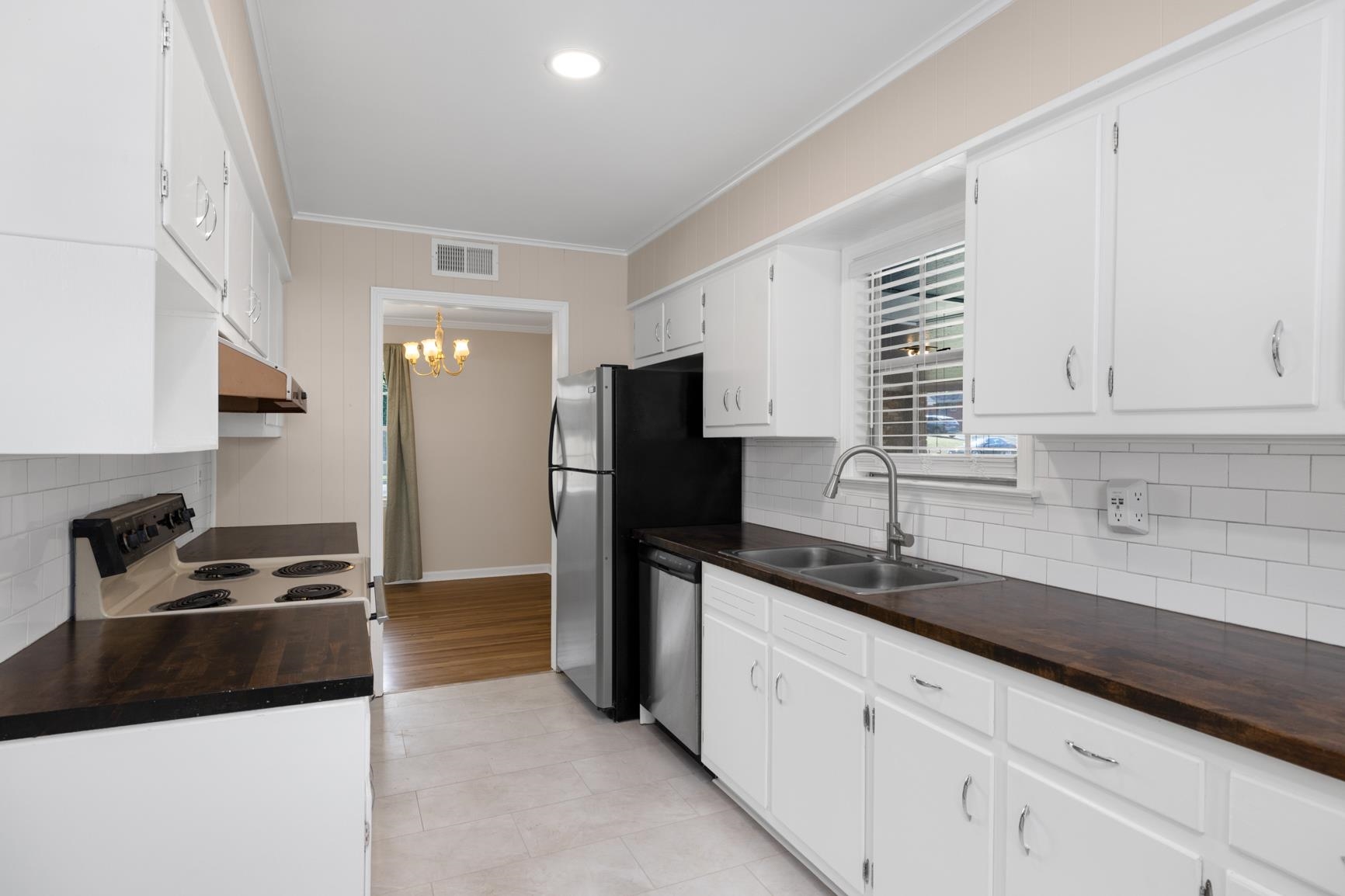 7223 Renda Street Millington, TN 38053 - Photo 9 of 24 a kitchen with granite countertop a sink cabinets and stainless steel appliances