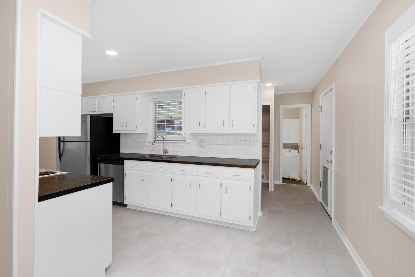 7223 Renda Street Millington, TN 38053 - Photo 10 of 24 a kitchen with granite countertop white cabinets and stainless steel appliances