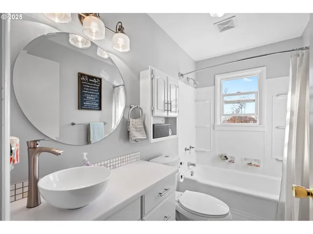 a bathroom with a sink a toilet and bathtub