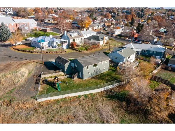 an aerial view of residential houses with outdoor space