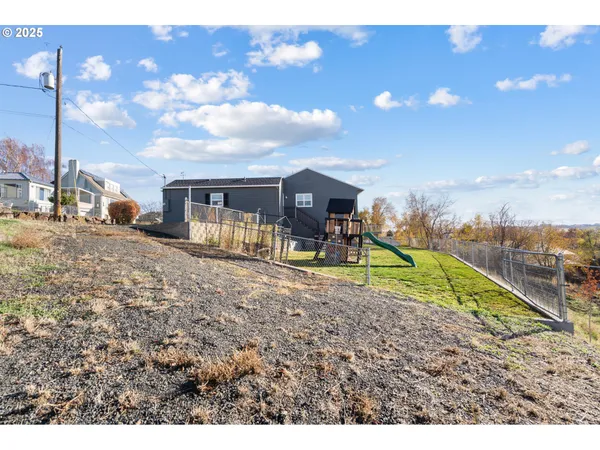 a view of a house with a backyard porch and furniture
