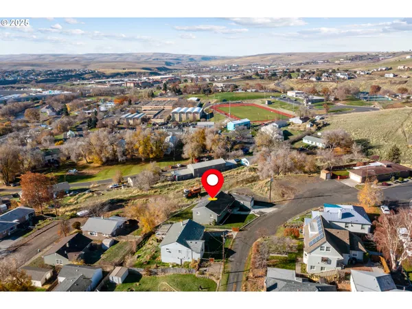 an aerial view of residential houses with outdoor space