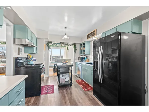 a kitchen with refrigerator and cabinets